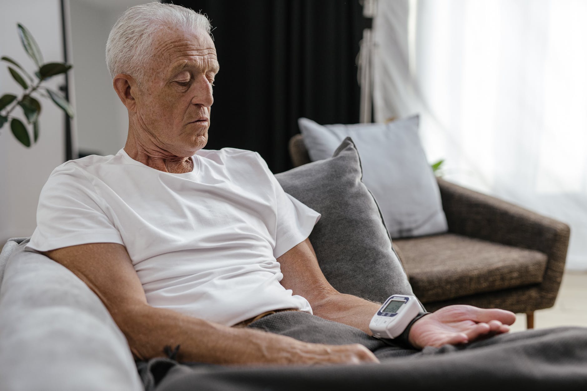 elderly man checking his blood pressure